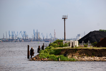 cargo shipping terminals in Riga, Latvia with high wind and dust flying over