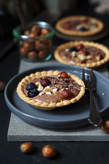 Tartletts mit Schokocreme, Haselnüssen, Blaubeeren und Topping