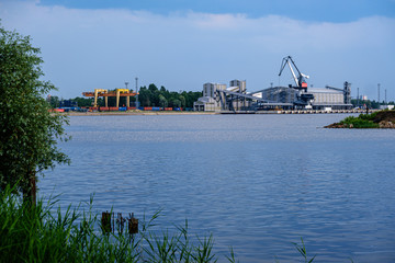 cargo shipping terminals in Riga, Latvia with high wind and dust flying over
