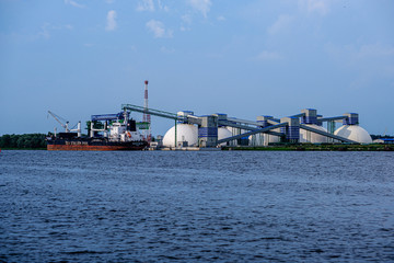 cargo shipping terminals in Riga, Latvia with high wind and dust flying over