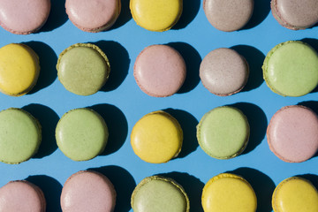An overhead view of macaroons on blue backdrop