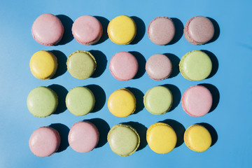 An overhead view of macaroons on blue background