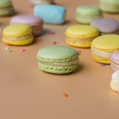 Green; yellow; pink; and blue macaroons on colored background