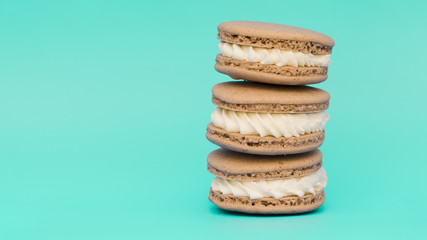 Stacked of macaroons on turquoise background