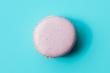Purple macaroon on blue background