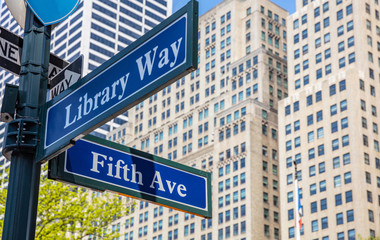 Fototapeta premium 5th ave and Library Way corner. Blue color street signs, Manhattan New York downtown