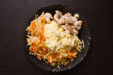 Dish of mashed potatoes, cabbage and carrot salad, fried diet chicken breast