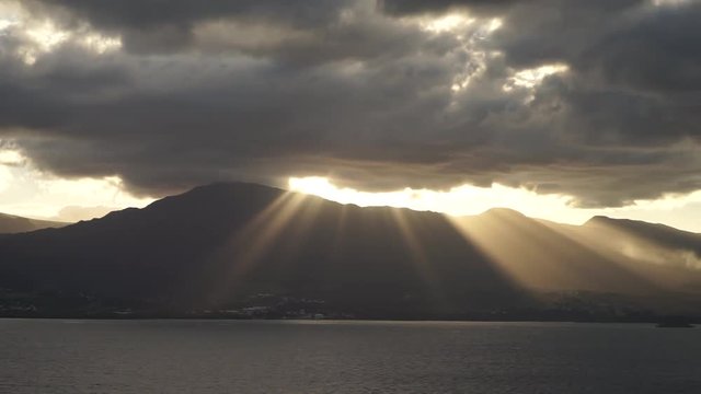 sunset with lots of rays over mountains of Guadeloupe island