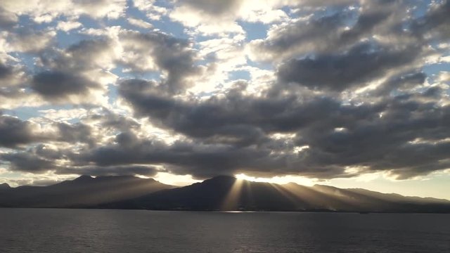 sunset with lots of rays over mountains of Guadeloupe island