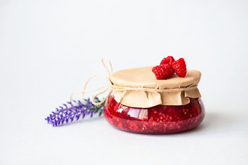 healthy fresh raspberries, homemade jam in a jar
