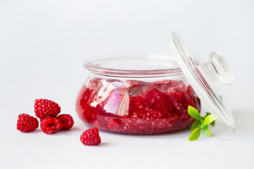 healthy fresh raspberries, homemade jam in a jar