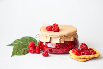 raspberries with sugar, healthy fresh raspberries, homemade jam in a jar, morning breakfast on a...