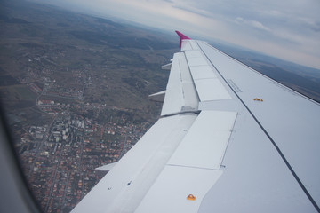 Fototapeta na wymiar An airplane window view of wing and flaps 