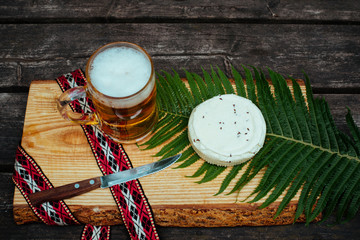 Latvian beer with latvian cheese and national folk belt