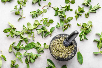Dried herb of mint, fresh leaves and dry mint in mortar, top view