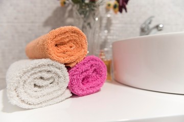 bathroom wrapped towels near sink