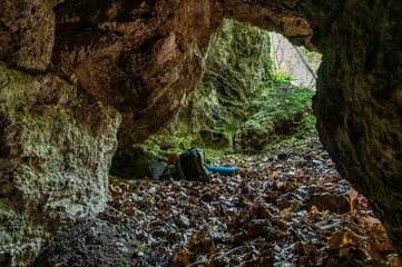 Backpack at the exit of the karst cave