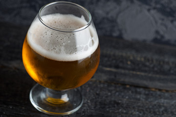 India peel ale in a misted glass on a dark background with copyspace