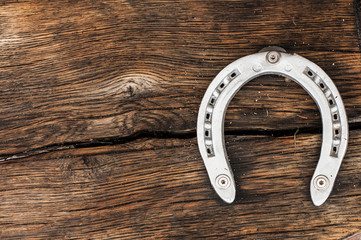 steel horseshoe on wooden background