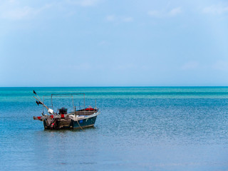 Unmanned small boat on the ocean – seascape with copy space