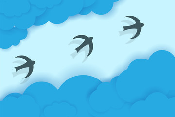 Three birds flying between blue clouds.