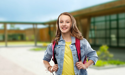 education and people concept - happy smiling teenage student girl with bag over school background