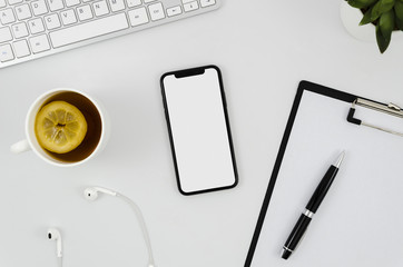 Top view smartphone template over workspace