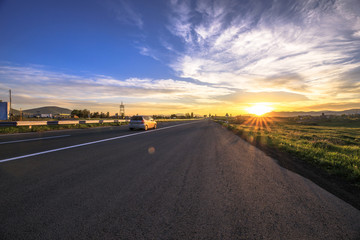 Naklejka premium corolful sunset with road