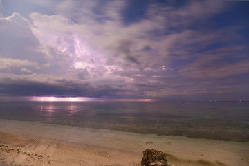 dramatic clouds scape in a thunderstorm with lightnings in the dark night sky photography with long...