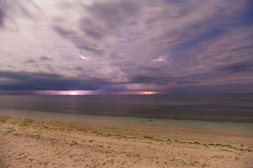 dramatic clouds scape in a thunderstorm with lightnings in the dark night sky photography with long...
