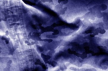 Dirty camouflage cloth with blur effect in blue tone.