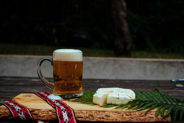 Latvian beer with latvian cheese and national folk belt