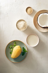 mango sticky rice with rice, coconut milk and sugar, sesame and mango background