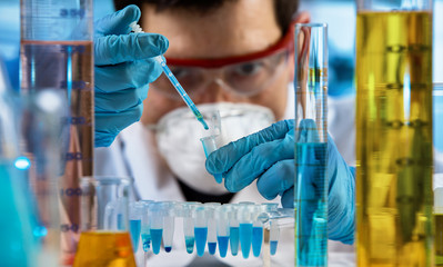 Researcher holding test tube for analysis with chemist material in the investigation lab