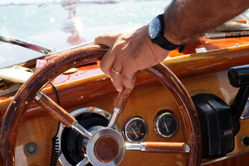 Captain steering a boat through the canals of Venice