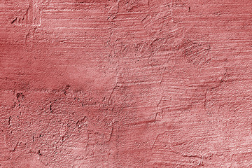 Сraked weathered cement wall texture in red color.