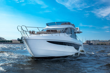 Fototapeta premium white yacht at river in city, luxury lyfe