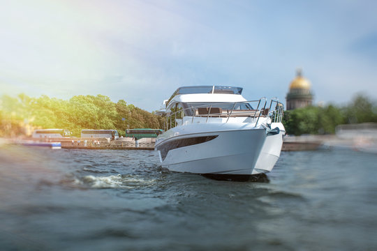white yacht at river in city, luxury lyfe