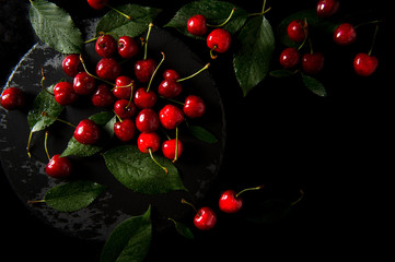 Sweet cherry. Sweet cherry on a dark background. Sweet cherry lies on the table. Drops of water on the cherry.