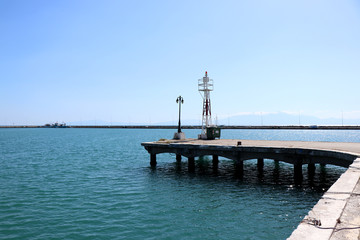 Fototapeta premium View of Nea Michaniona port, suburb of Thessaloniki, Greece. Pier and lighthouse. 