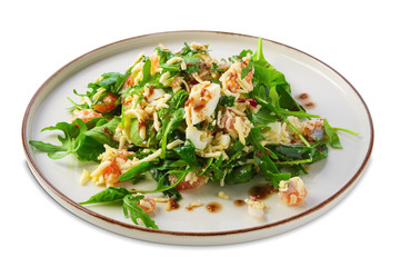 Salad with shrimps, arugula, cucumber, cheese and balsamic sauce isolated on white