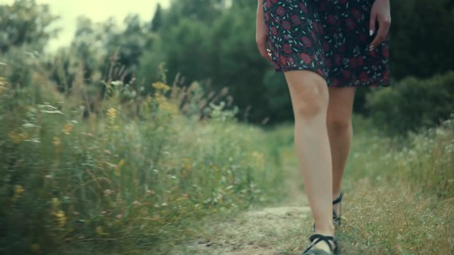 Happy Woman Walking In Summer Field.Wicker Hat.Woman In Hat Walking On Field.Woman In Hat.Romantic Female Walking.Girl Relaxing.Girl Walks Through Field.Pretty Ledy In Dress.Girl In Sunglasse. Enjoing