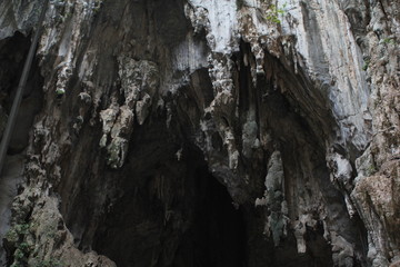 dark cave with a hole at the top from where the light of the sun falls