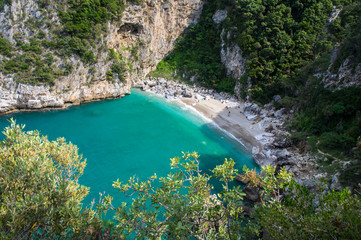 Fototapeta na wymiar Fakistra beach in Greece. Rocky cliffs and clear turquoise sea