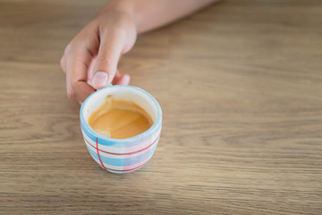 Hands holding a cup of hot coffee