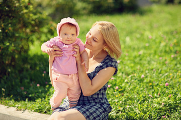 happy loving mother and her baby outdoors. Child and mom