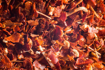 Crushed red hot peppers.Suns mixed with peel close-up background. Macro shooting.