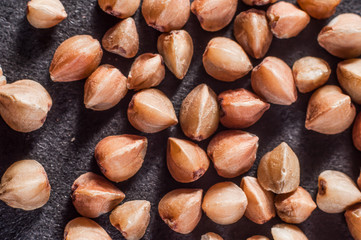 form and structure of buckwheat cereal closeup on a dark background. Macro shooting.