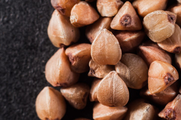form and structure of buckwheat cereal closeup on a dark background. Macro shooting.