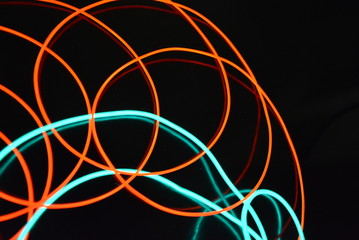 Neon green and red thin wire. Luminous wires, decoration and illumination of the surface. Electroluminescent wire, lighting objects and light base.